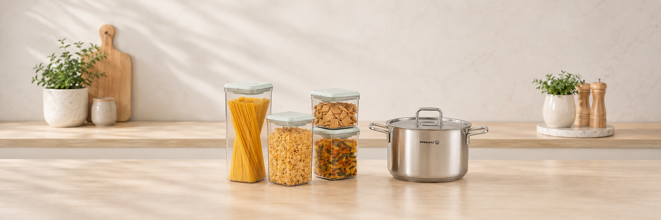 Curated cookware and kitchen storage essentials arranged on a soft beige background for The Wola Home & Kitchen collection
